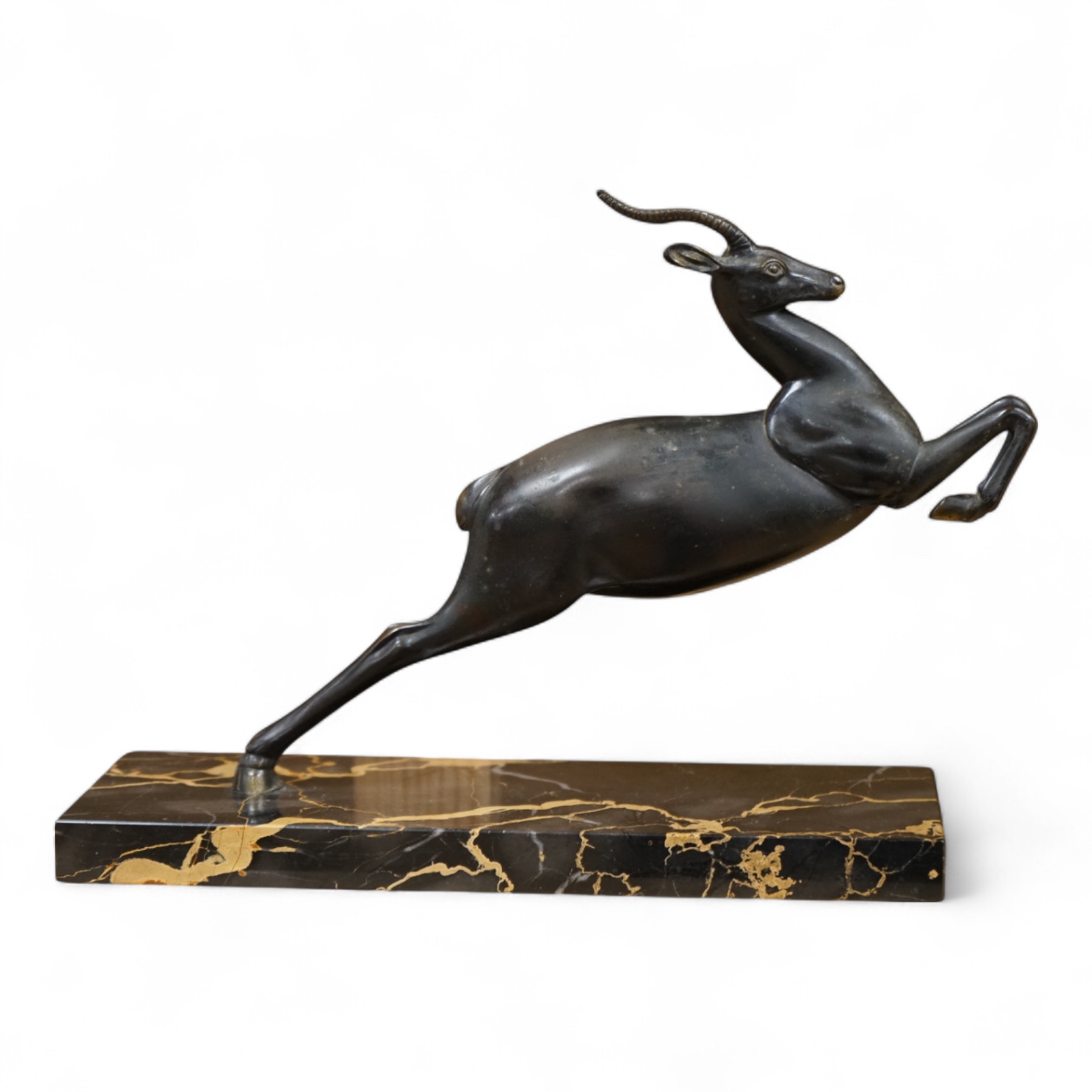 An Art Deco spelter study of a leaping gazelle, 27cm wide